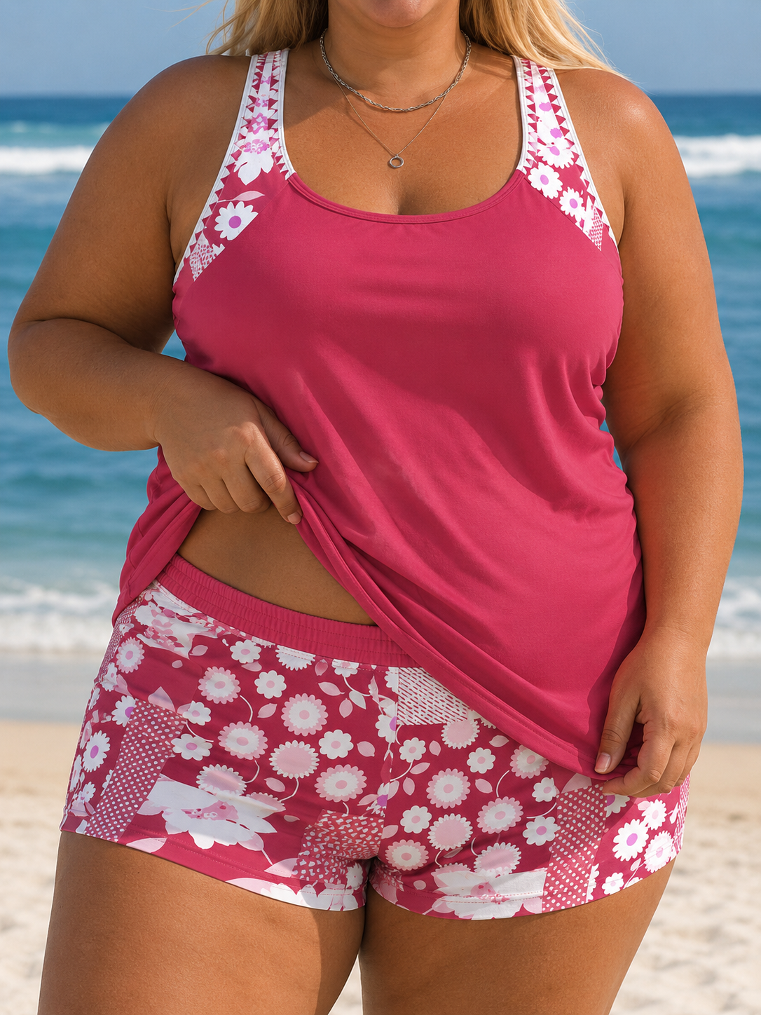 Tankini top in a vibrant pink with floral straps, paired with matching printed shorts featuring a lively pattern.