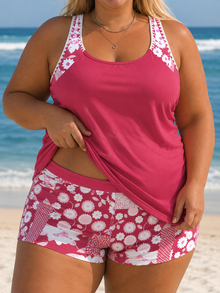 Tankini top in a vibrant pink with floral straps, paired with matching printed shorts featuring a lively pattern.