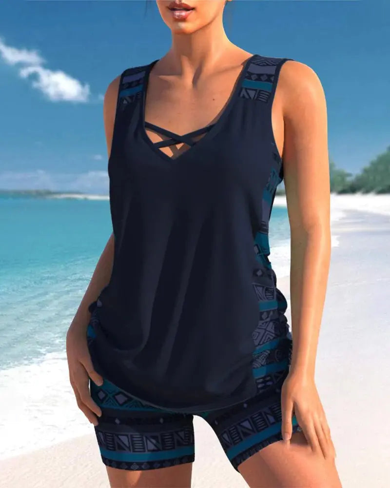 Dark navy two-piece tankini featuring a structured neckline, sleeveless top, and patterned shorts with blue accents.