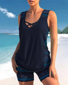 Dark navy two-piece tankini featuring a structured neckline, sleeveless top, and patterned shorts with blue accents.