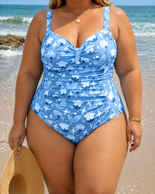 Classic one-piece swimsuit in blue with a floral print, featuring a front knot detail and ruched sides.