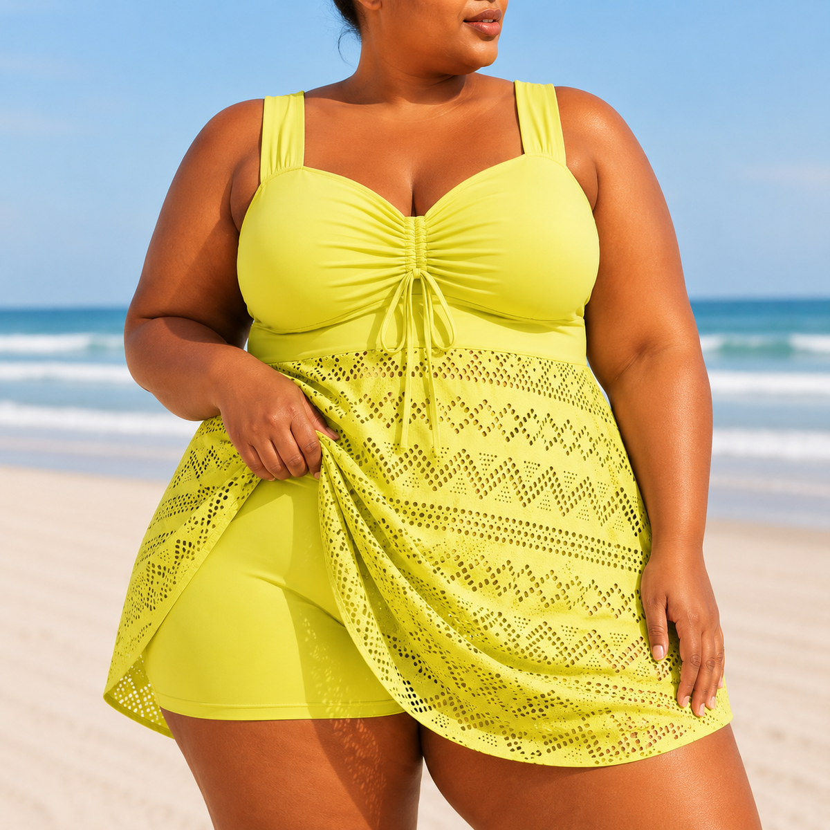 Flowing overlay swim dress in vibrant yellow, featuring a structured top and chevron patterned skirt overlay.