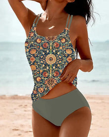Two-piece tankini featuring a vibrant floral print top with a U-neck and high-waisted solid gray bottoms, styled for beach wear.