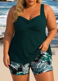 Pleated tankini top in dark green paired with matching printed shorts featuring a black and green wave pattern.