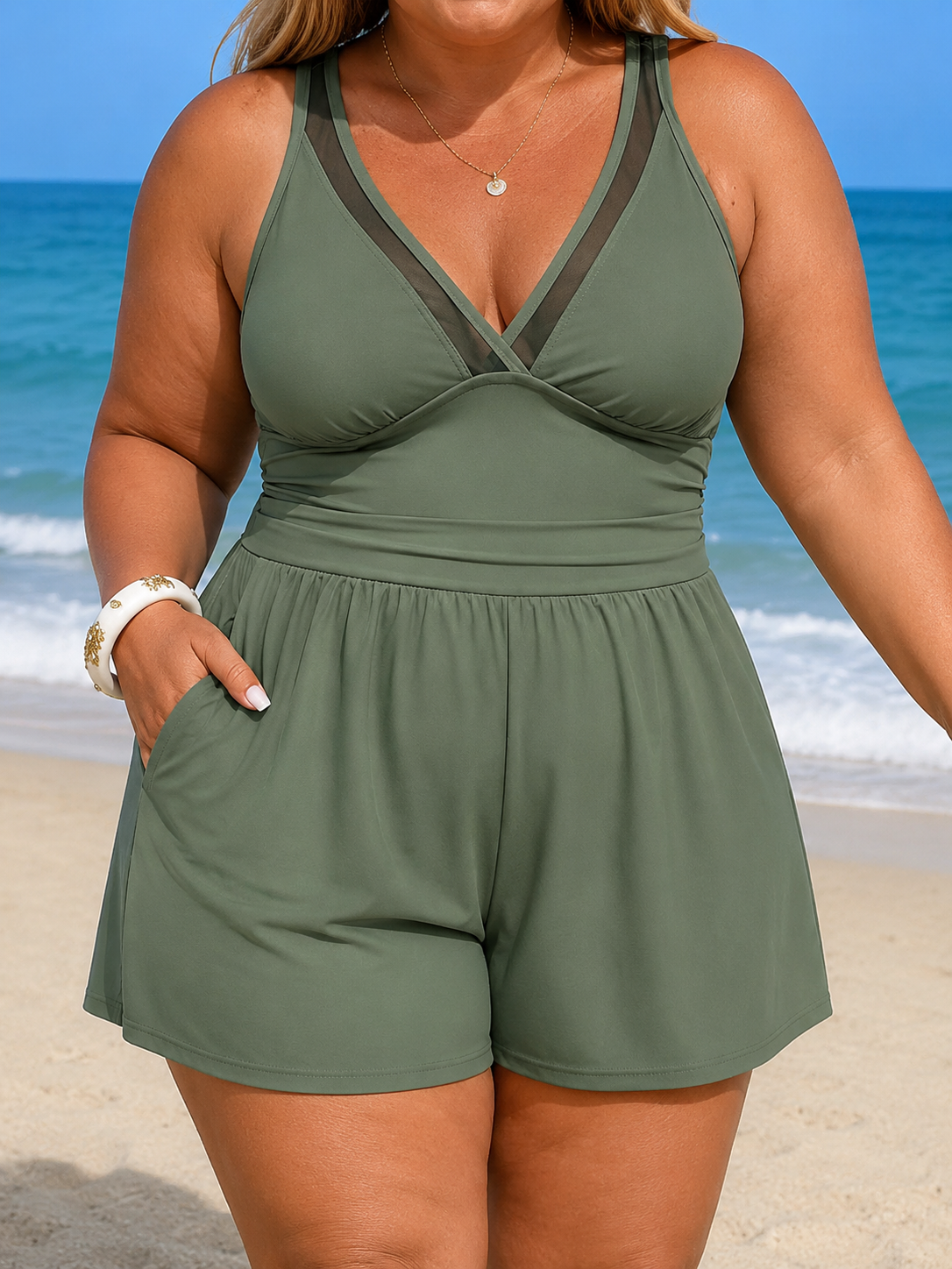 V-neck swim dress in olive green with wide straps and built-in shorts, featuring a skirted length for coverage.