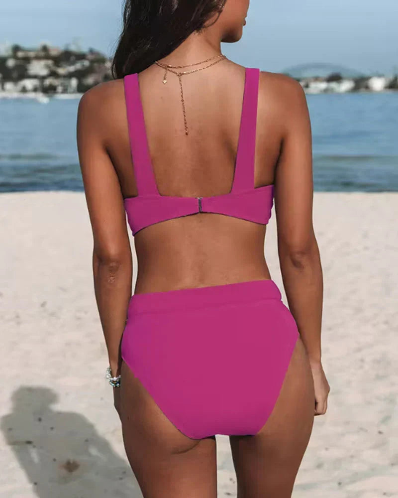 Women's knit bikini set in bold pink, featuring a V-neck top with wide straps and a high-waisted bottom.