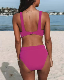 Women's knit bikini set in bold pink, featuring a V-neck top with wide straps and a high-waisted bottom.