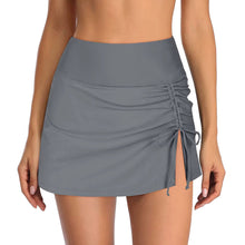 Gray swim shorts with a wide waistband, drawstring, side slit, and ruched detailing on one side, styled for beach wear.